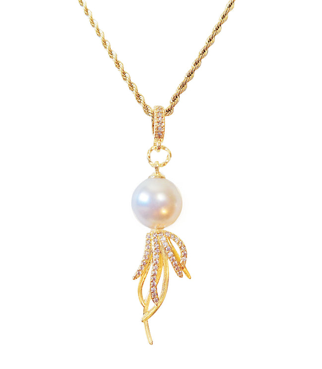 Pearl pendant necklace with gold chain on a white background
