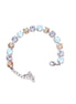 Multicolored tennis  bracelet on a white background.Made with genuine Austrian crystal.A single row of crystals in colours white opal.clear rystal and golden.The bracelet is medium size and fits average wrist.It includes and extension chai
.It is rhodium silver plated nickel free