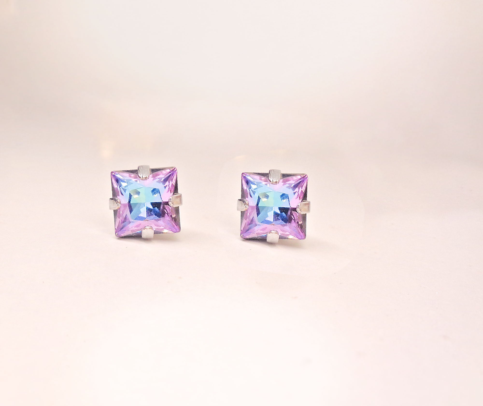 Square stud earrings made with Austrian crystal.These are square stud earrings 8mm size in colour vitrail light which is purple with light blue hues .They are silver plated nickel free.Elegant square earrings