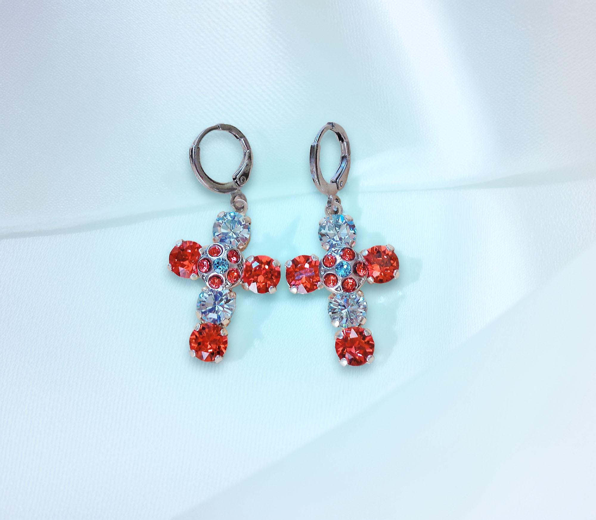 Cross-shaped earrings with red and clight blue gemstones on a light blue 
background
These are made with real Austrian crystals .Rhodium silver plated nickel free 