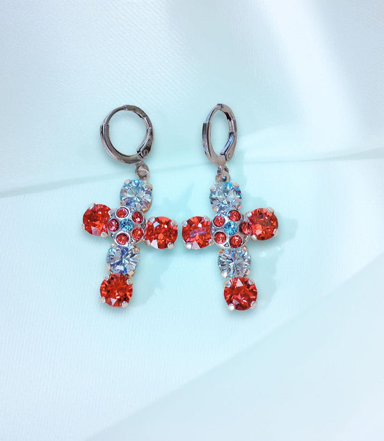 Cross-shaped earrings with red and clight blue gemstones on a light blue 
background
These are made with real Austrian crystals .Rhodium silver plated nickel free 