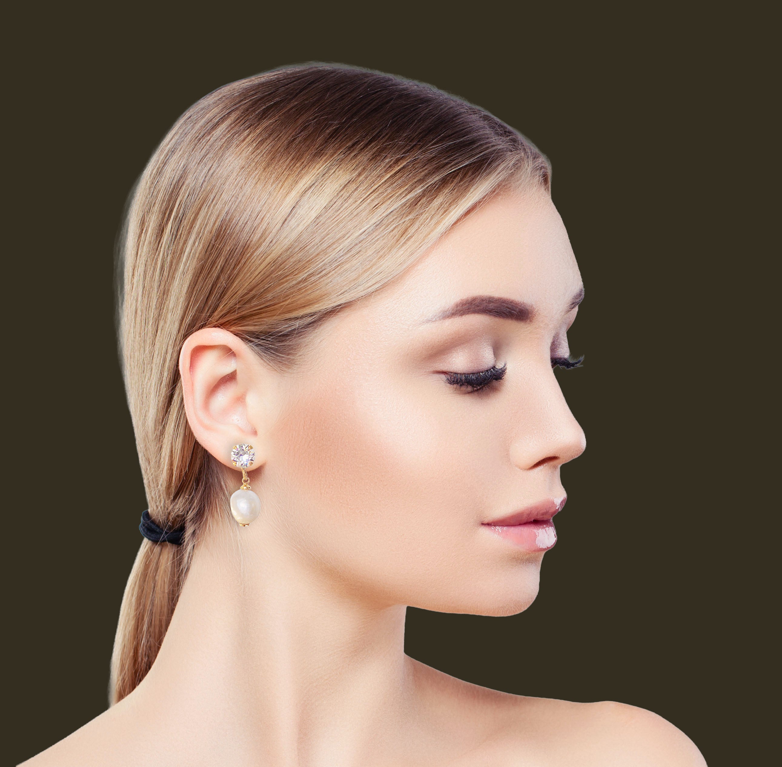profile of a lady wearing stud and pearl drop earring in colour clear crystal and white.The studs are  gold plated with an 8mm round crystal on top and a  white freshwater pearl hanging below the stud.